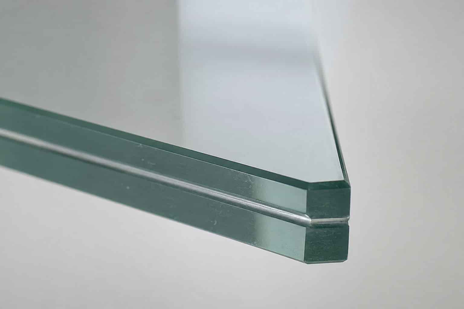 Close-up of a laminated glass edge showing two glass layers bonded with a plastic interlayer
