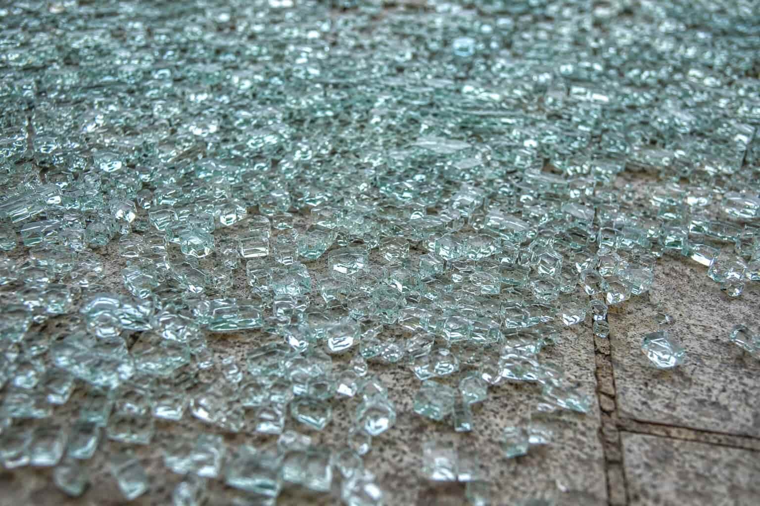 Close-up of shattered tempered glass showing characteristic small blunt fragments